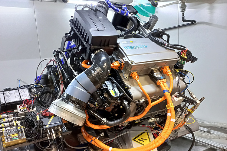 Hydrogen fuel cell system with orange high-voltage cables in a test setup