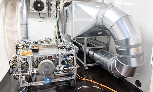 Rear view of grey vehicle taillights on with fog in background
