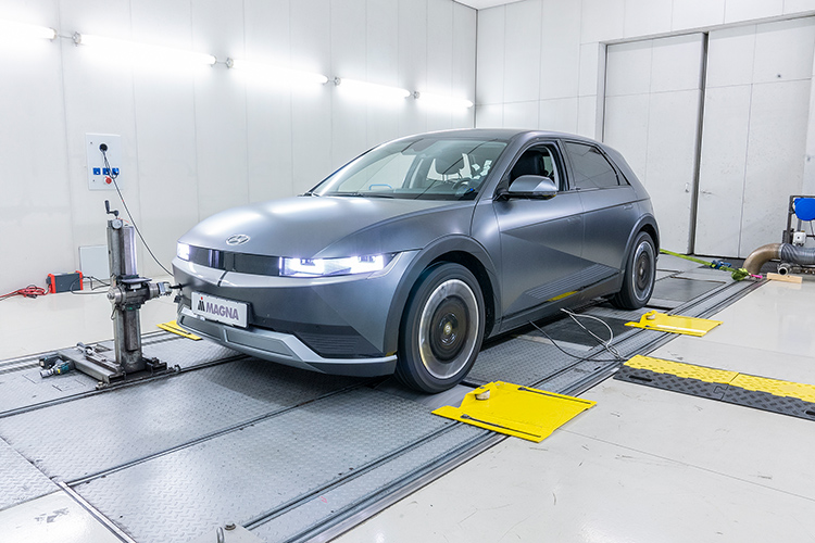Rear view of grey vehicle taillights on with fog in background