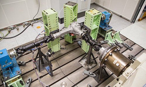 Rear view of grey vehicle taillights on with fog in background