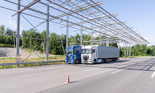 Rear view of grey vehicle taillights on with fog in background